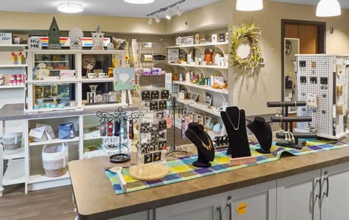A cozy retail shop featuring a variety of jewelry and gift items on display.