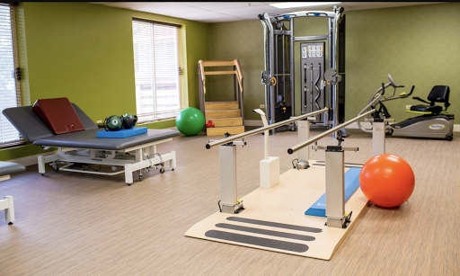 A well-equipped gym space designed for fitness and rehabilitation exercises.