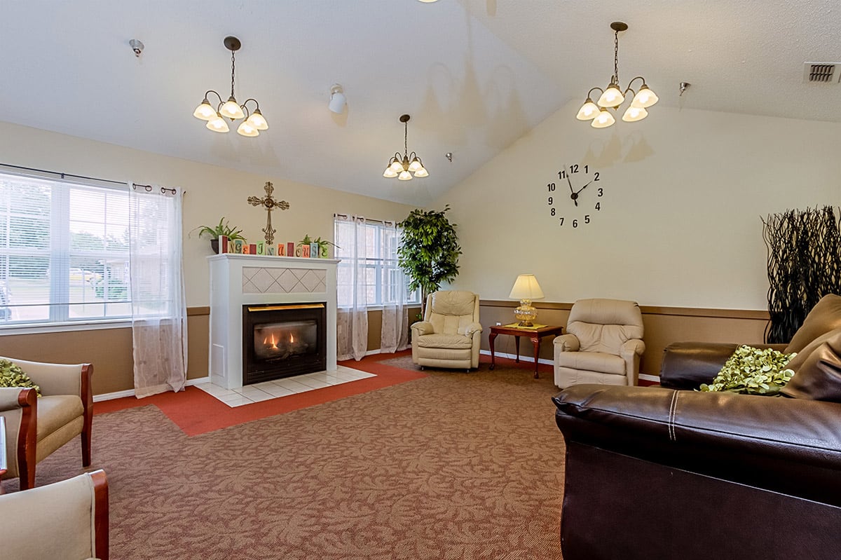 A cozy living room with a fireplace and comfortable seating.