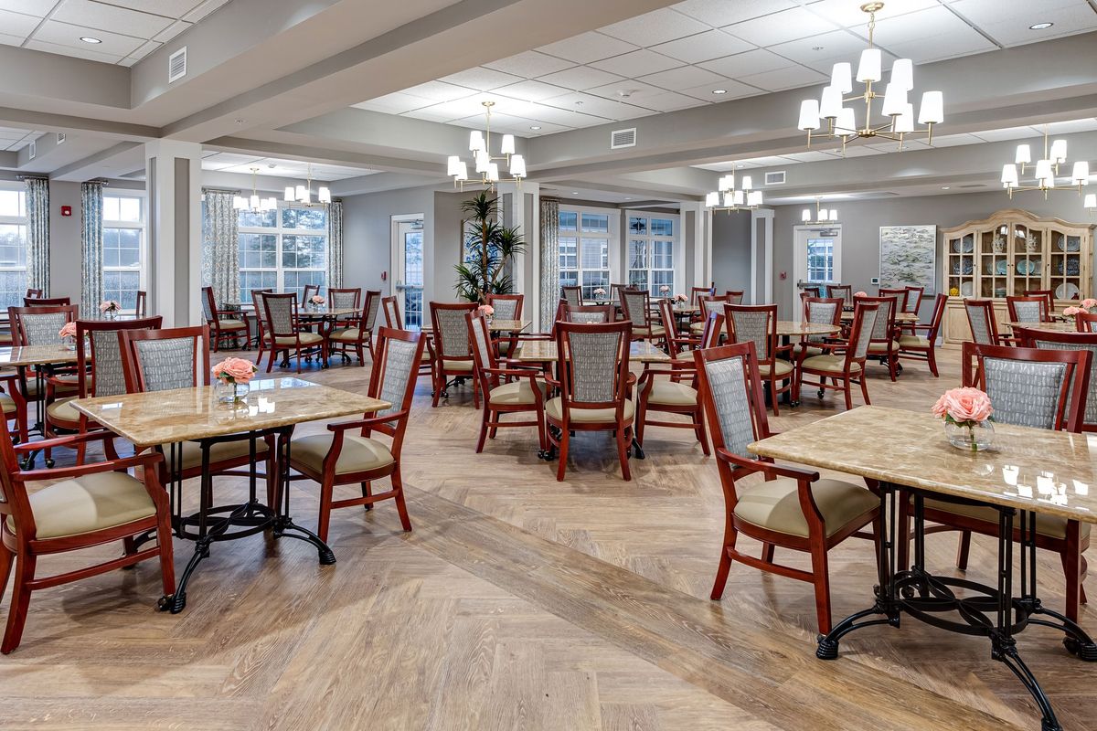 A spacious dining room with elegant decor and neatly arranged tables and chairs.