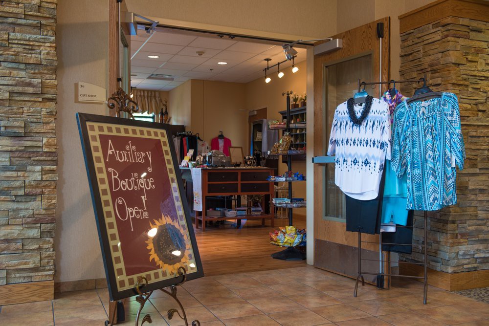 Entrance to a boutique showcasing clothing and sale items.