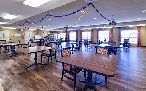 A spacious dining area featuring multiple tables and decorative streamers.