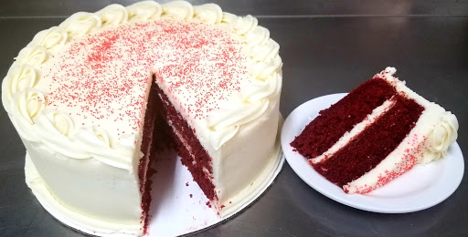 A delicious red velvet cake topped with creamy frosting, perfect for any celebration.