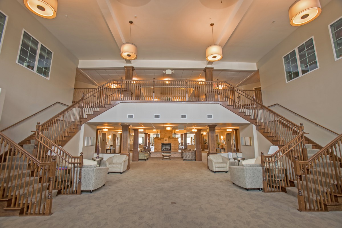 Spacious lobby with elegant staircases and comfortable seating.