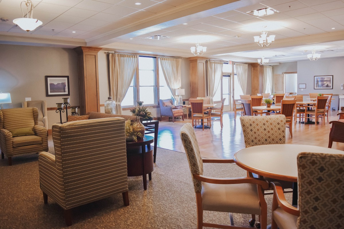 A well-lit lounge area with comfortable seating and large windows.
