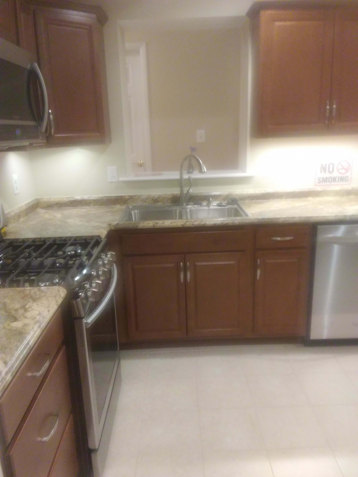 Modern kitchen with wooden cabinets and built-in appliances.