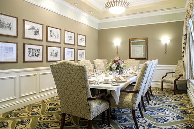 An elegant dining room with a formal table setting and classic decor.
