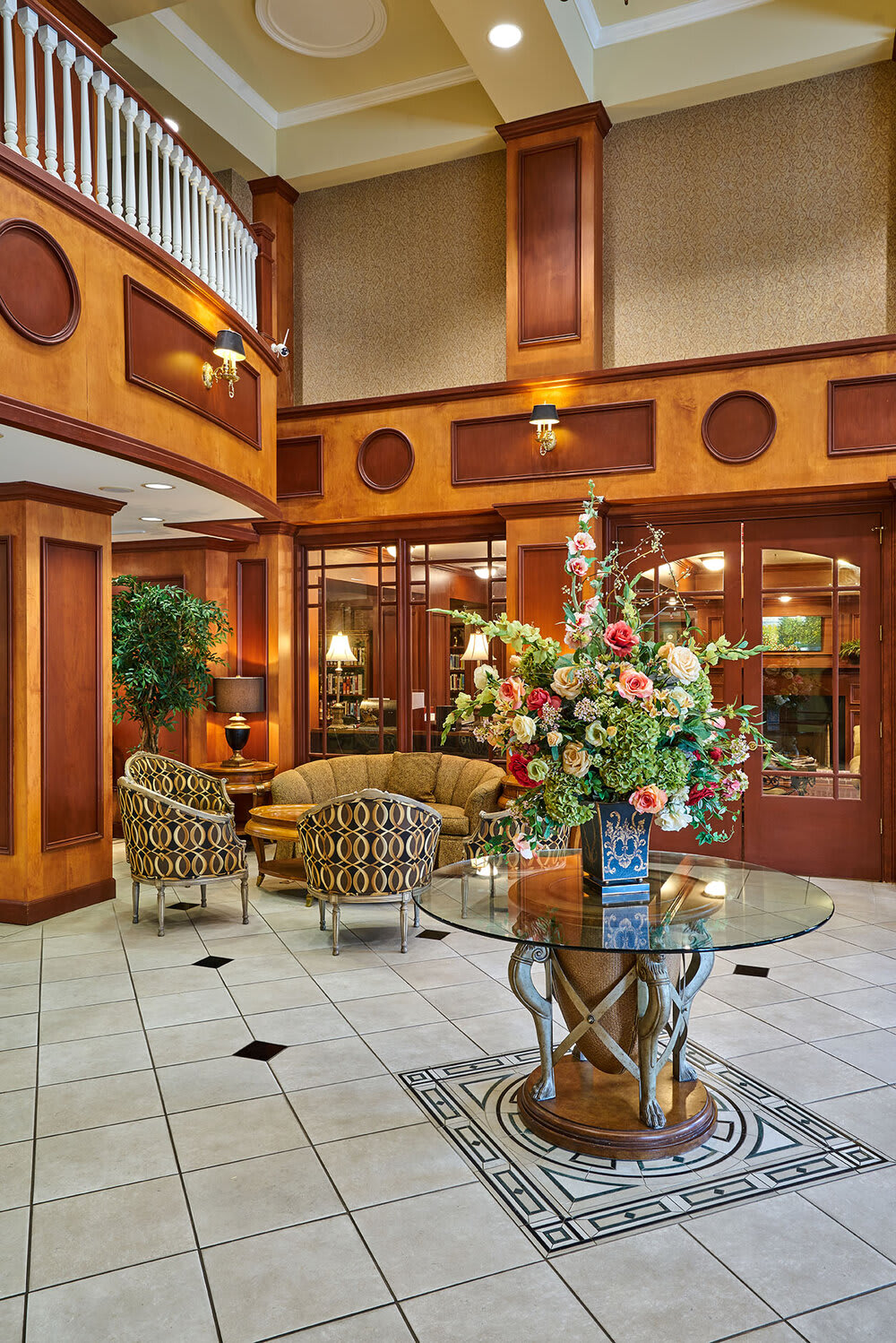 An elegant hotel lobby with stylish furniture and floral decorations.