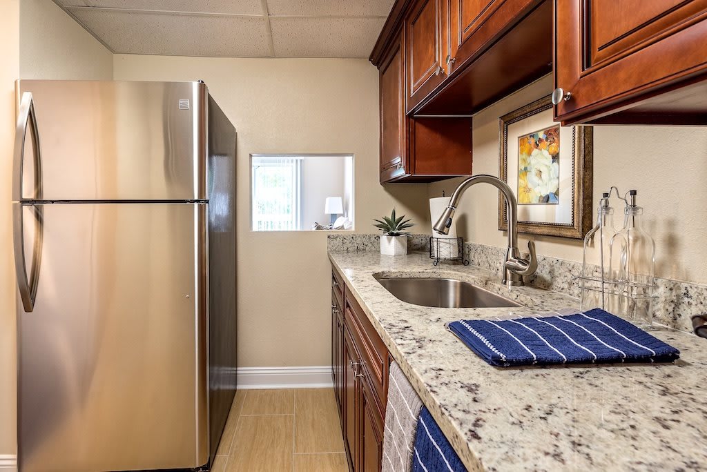 A modern kitchen with stainless steel appliances and granite countertops.