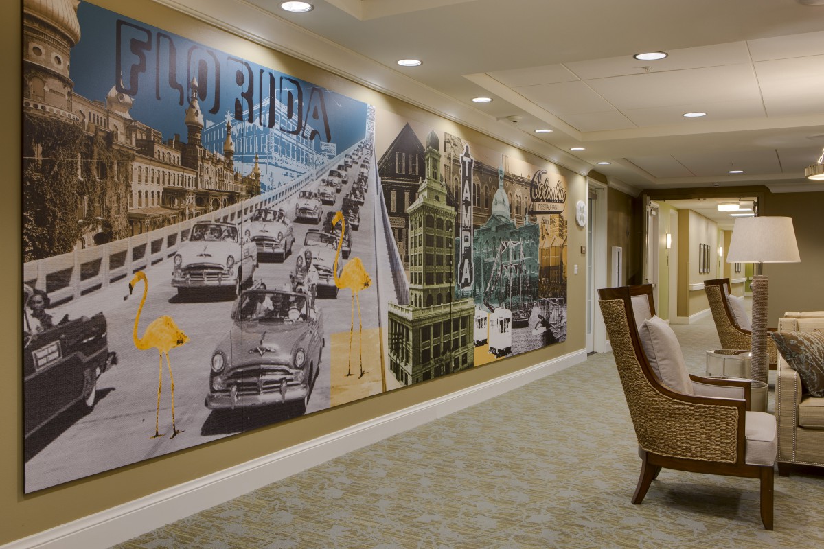A hallway features a large mural with vintage cars and architectural elements.