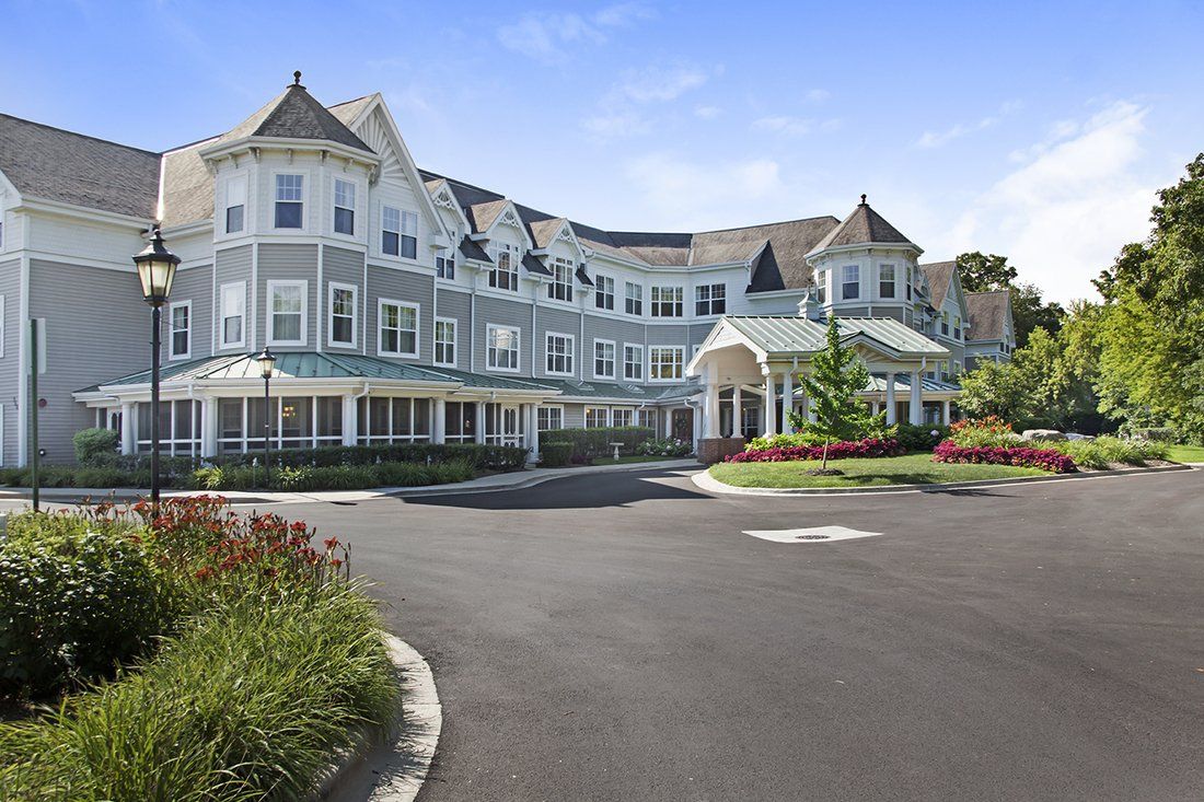 A large, picturesque building with Victorian-style architecture and manicured gardens.