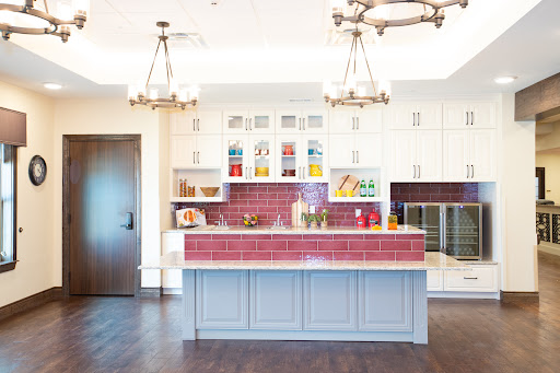 A bright and modern kitchen featuring colorful accents and stylish lighting.