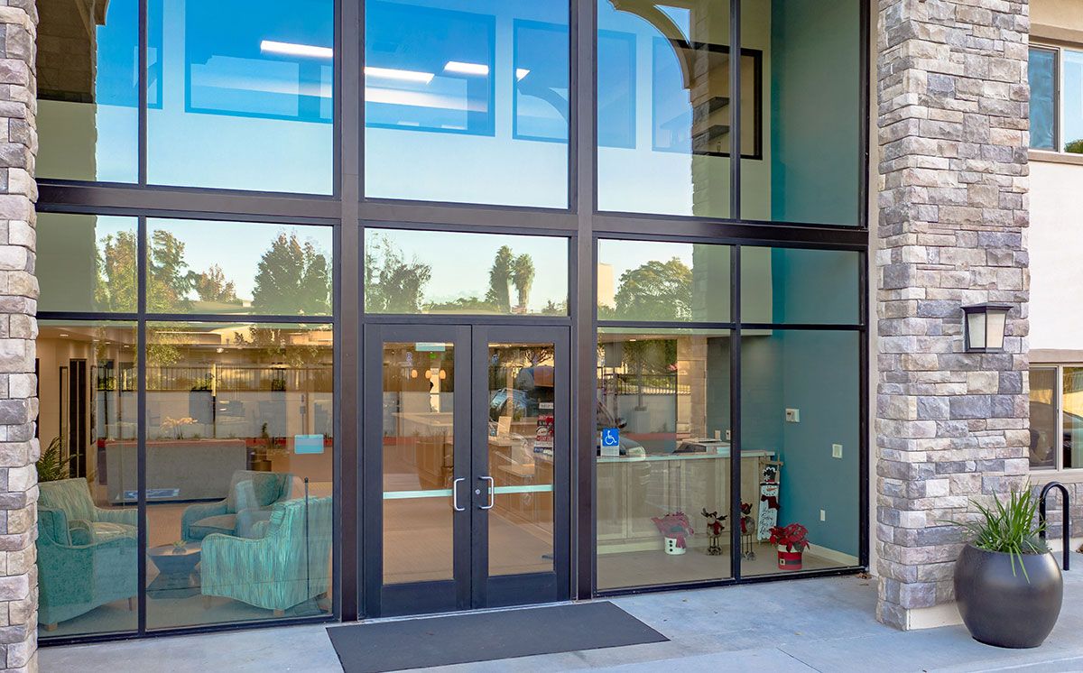 A modern building entrance with large glass windows and doors.