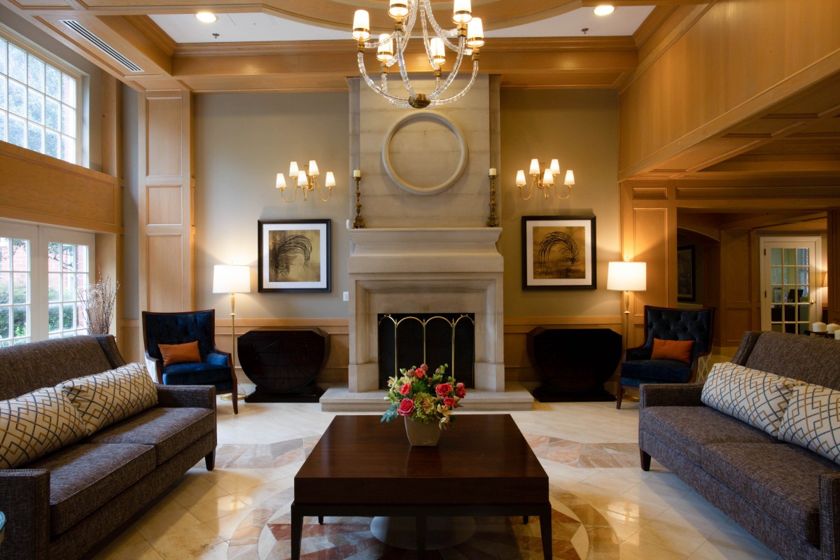 A luxurious living room with elegant decor and a central fireplace.