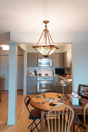An inviting kitchen and dining area featuring modern appliances and elegant lighting.
