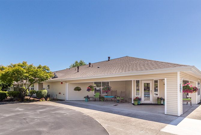 A single-story residential house with a driveway and landscaped entrance.