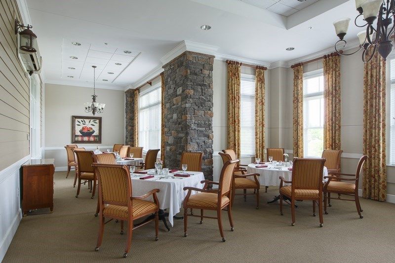 A well-lit restaurant dining area featuring neatly arranged tables and chairs.