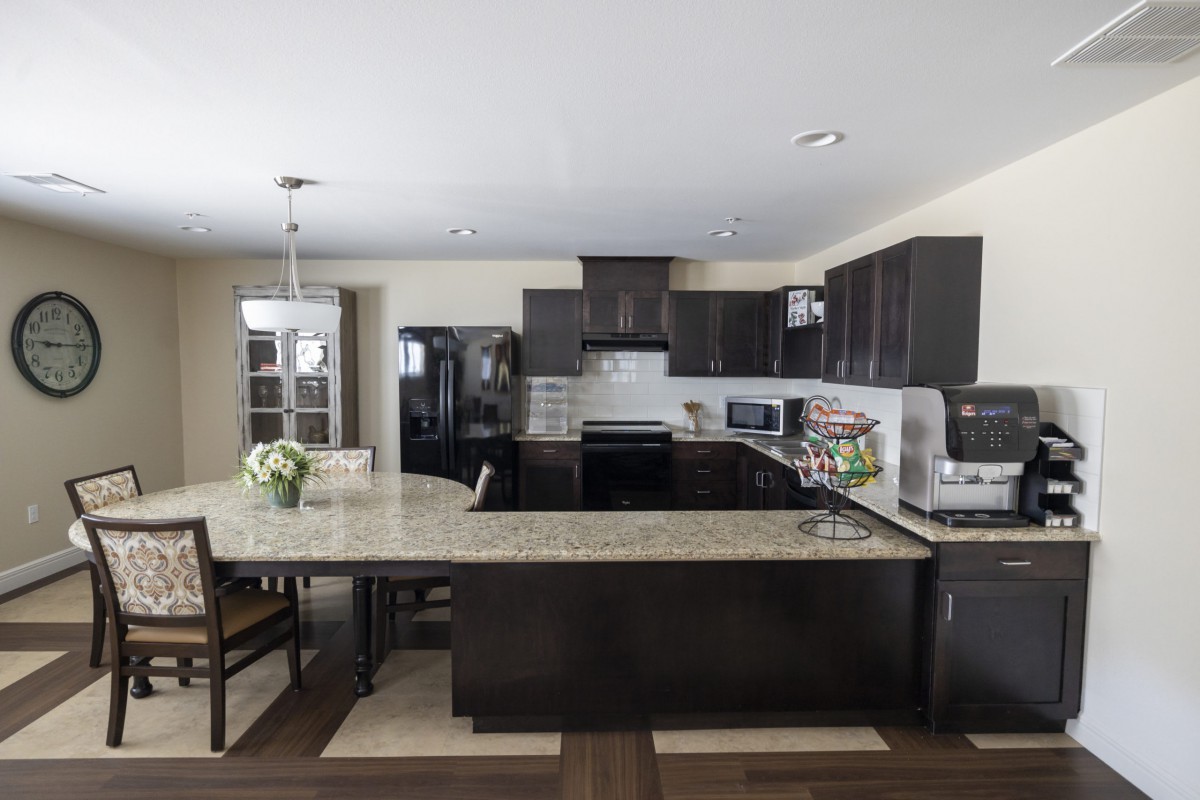 A modern kitchen with dark cabinetry and a spacious island.