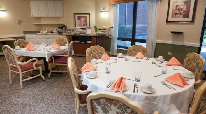 A elegantly set dining table with folded napkins in a formal restaurant setting.