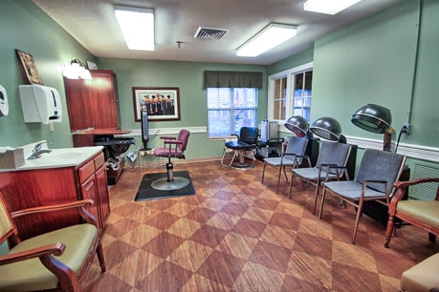 A well-lit hair salon interior with styling chairs and hair dryers.