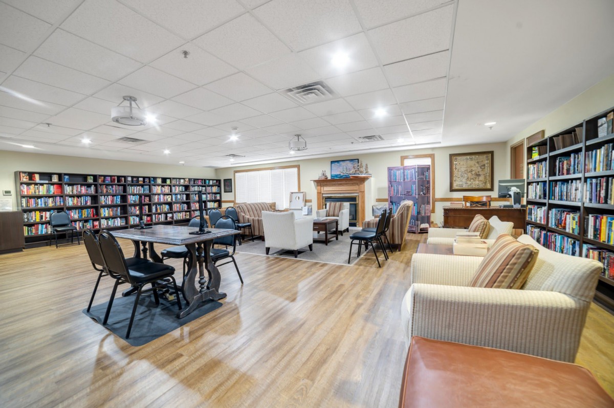 A cozy library space with ample seating and bookshelves, ideal for reading and relaxation.