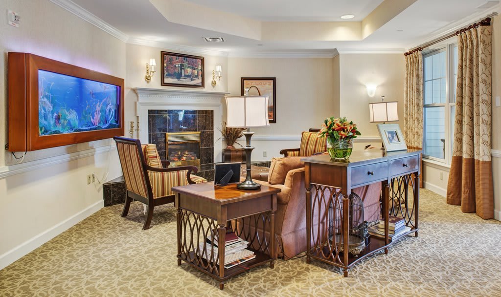 A cozy living room with elegant furniture and a warm fireplace.