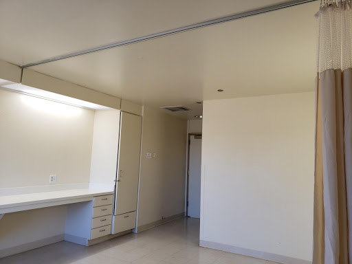 A minimalist interior view of an empty room featuring plain walls and a simple design.