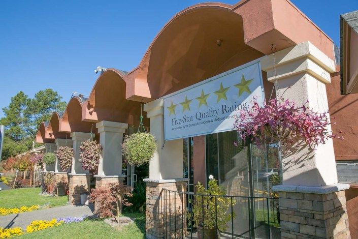 The exterior of a hotel with an elegant architectural design and well-maintained landscaping.