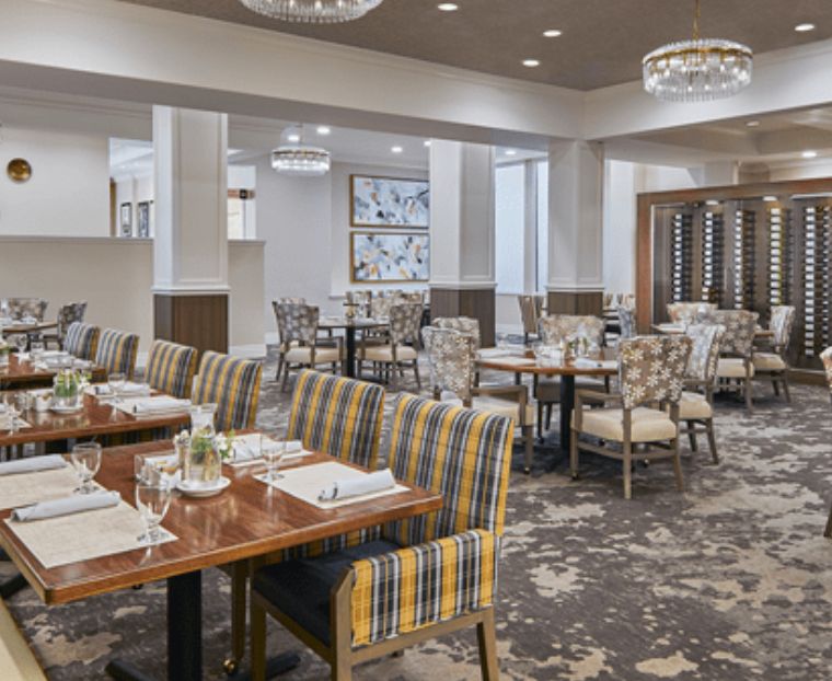 A modern and elegant dining area in a restaurant, featuring neatly arranged tables and stylish chairs.