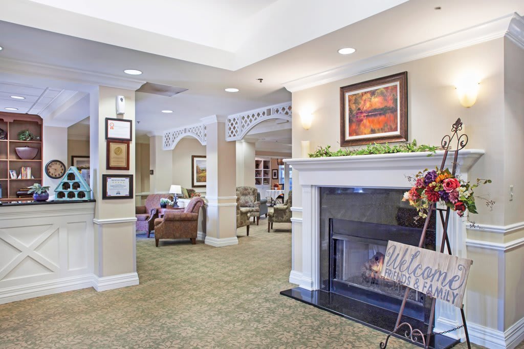 A cozy living room interior featuring a fireplace and comfortable seating.
