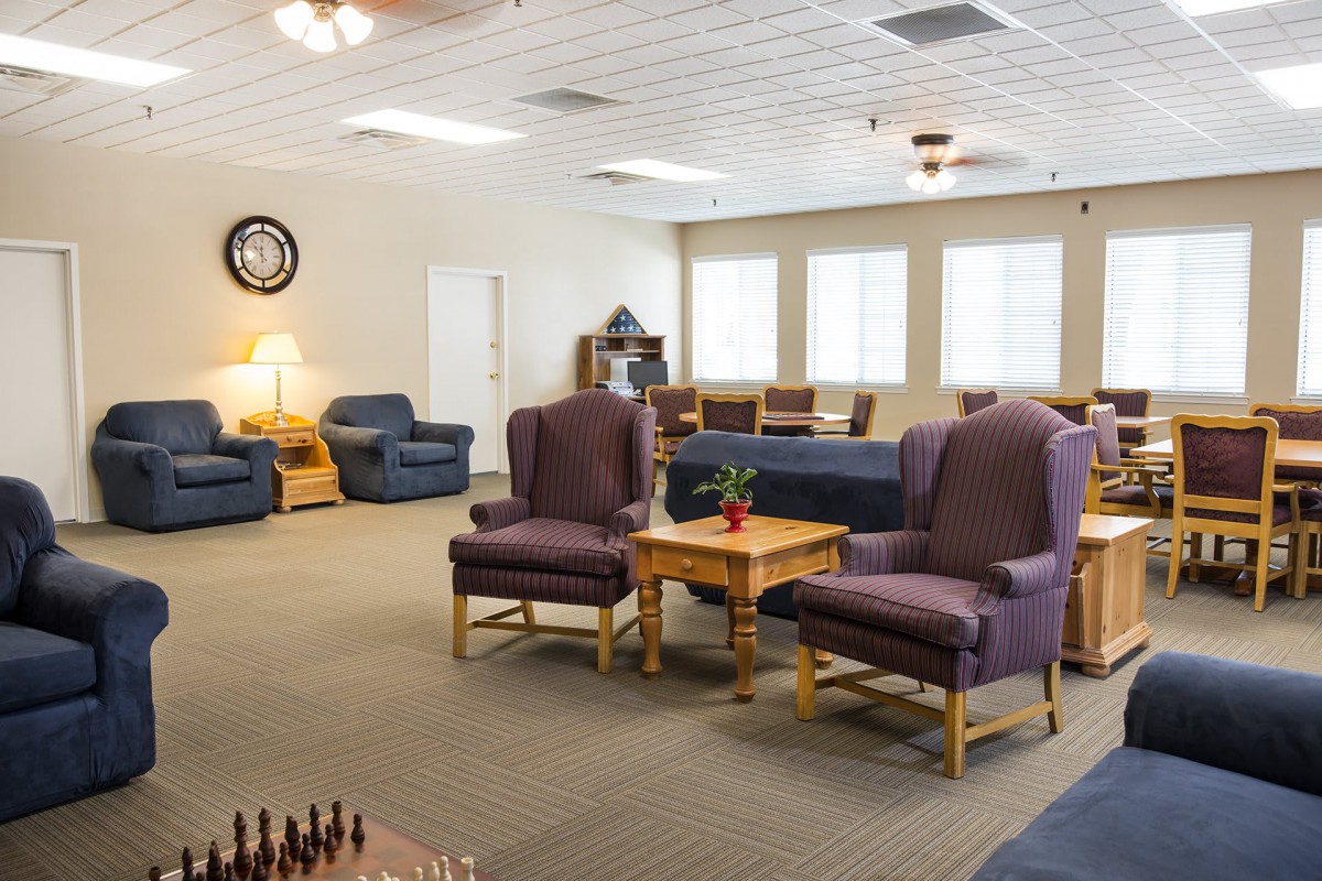 A cozy living room with comfortable seating and ambient lighting.
