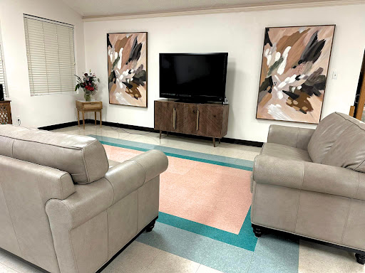 A cozy living room featuring contemporary furniture and artistic wall decor.