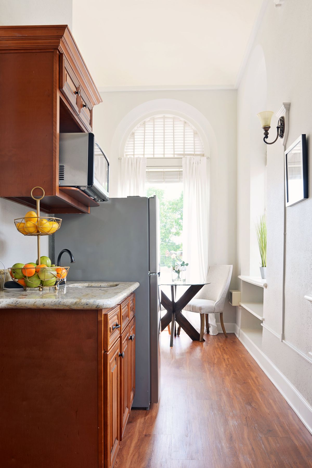 A bright kitchen and dining area with wooden cabinets and a modern design.