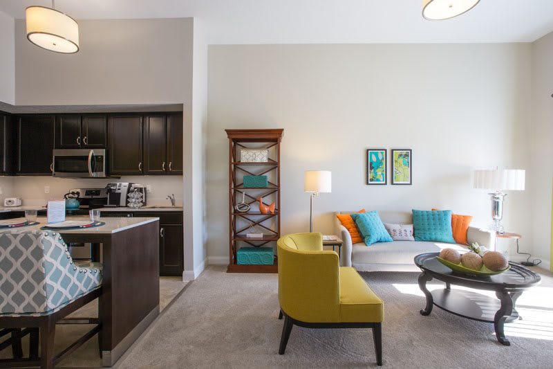 A modern living room with colorful decor and comfortable seating arrangements.