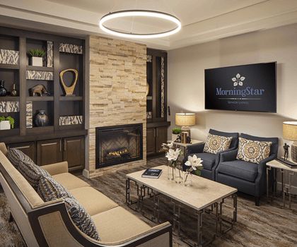 A modern living room featuring a cozy seating area with a fireplace, sleek furniture, and contemporary decor.