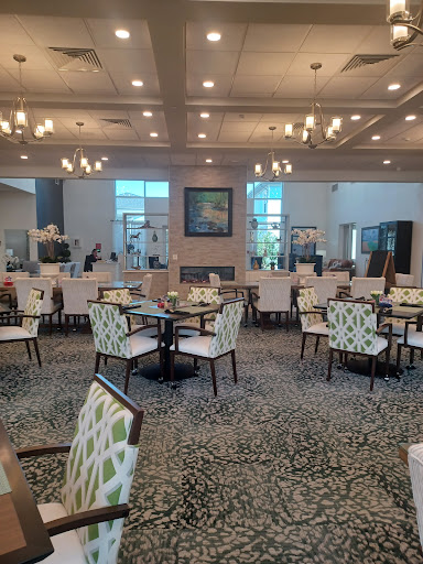 A beautifully arranged dining area in a modern restaurant, featuring stylish furniture and ambient lighting.