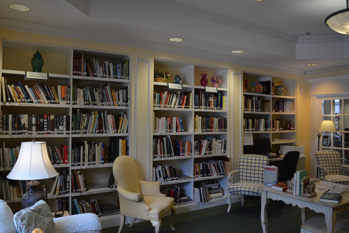 A cozy library space with bookshelves and comfortable seating.