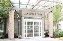 Entrance to Landow House with glass doors and a canopy.