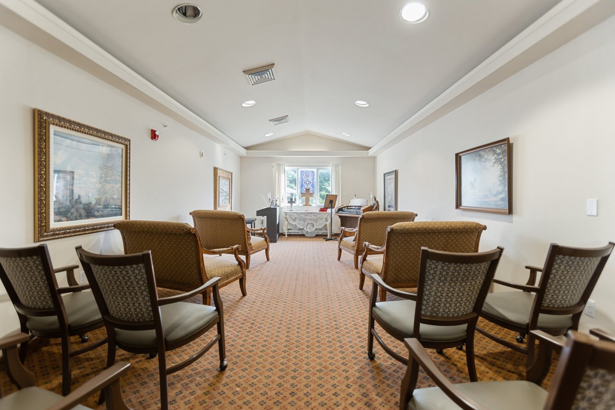 A well-lit waiting room with comfortable seating and a carpeted floor.