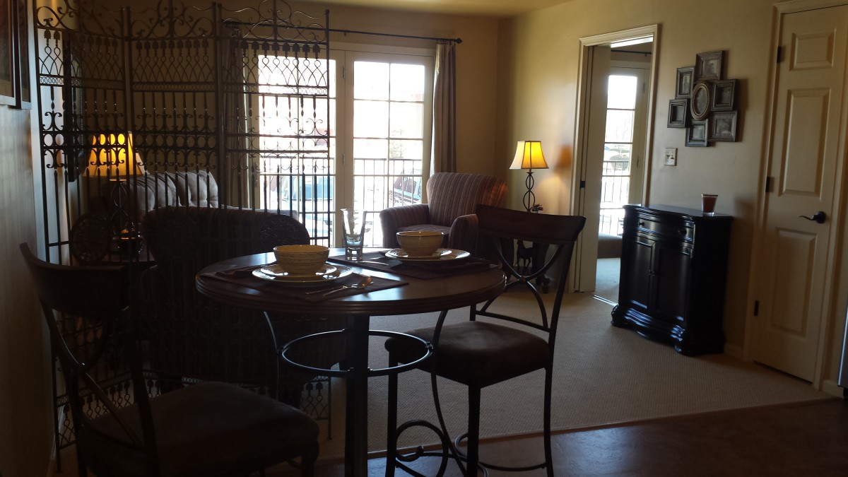 Cozy living room with a dining area and bright natural lighting.