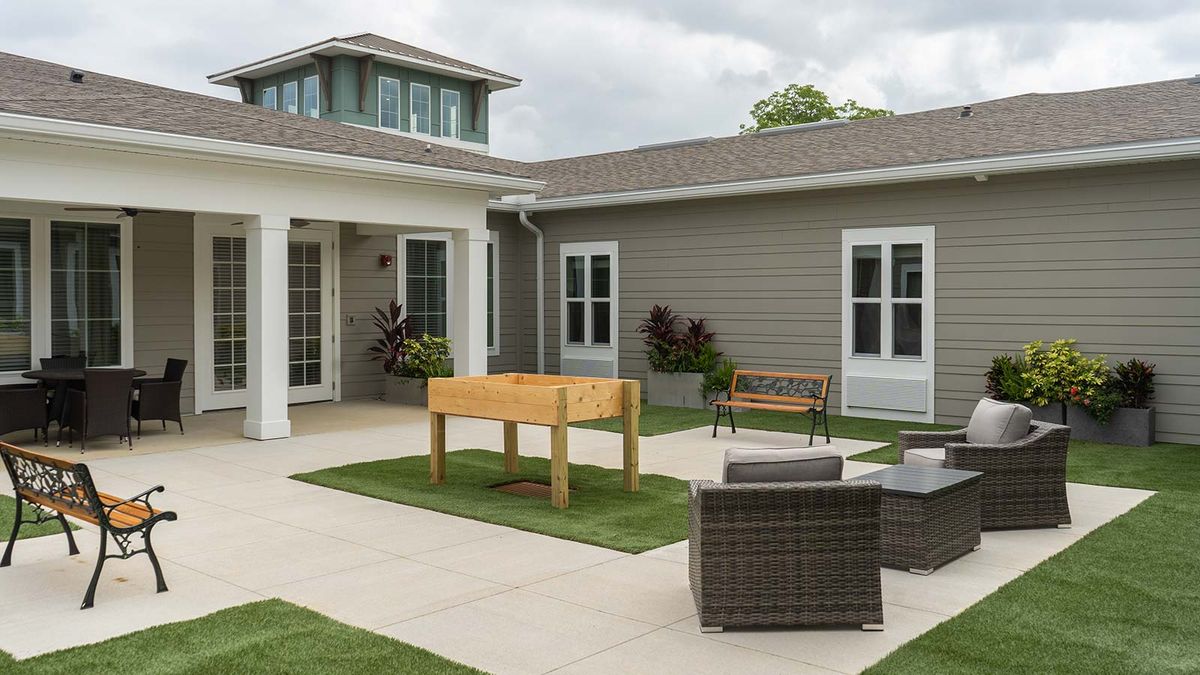 A modern courtyard with outdoor furniture and a landscaped design.
