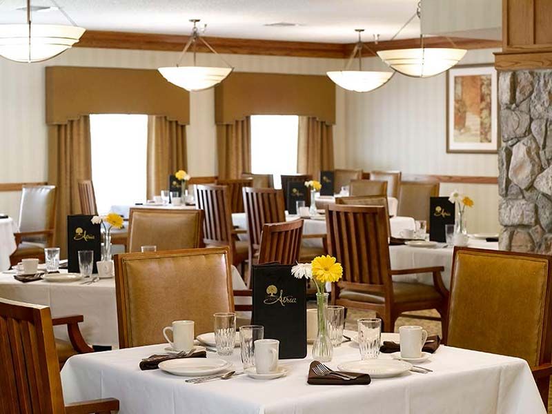 A well-appointed restaurant dining room with neatly arranged tables and chairs, creating an elegant and formal atmosphere.