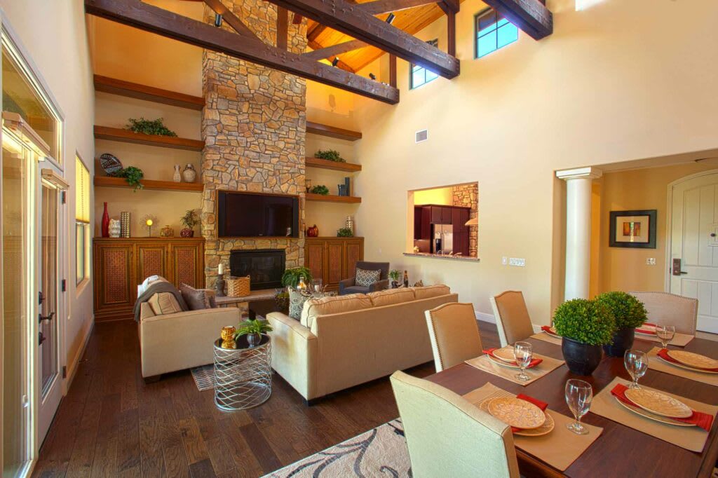 A modern and cozy living room with a fireplace and an adjoining dining area.