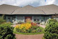A charming house with a beautifully landscaped garden in front.