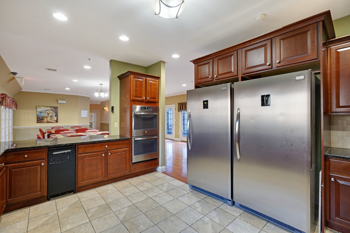 A modern kitchen with stainless steel appliances and wooden cabinets.