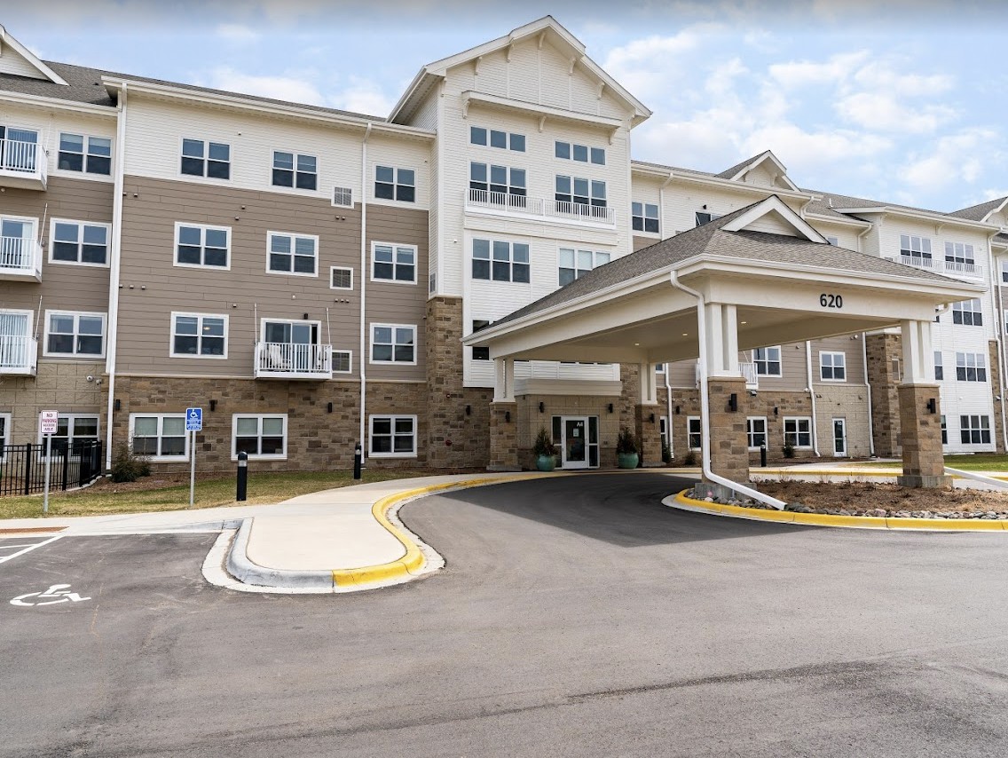 A multi-story residential building with an entrance canopy.