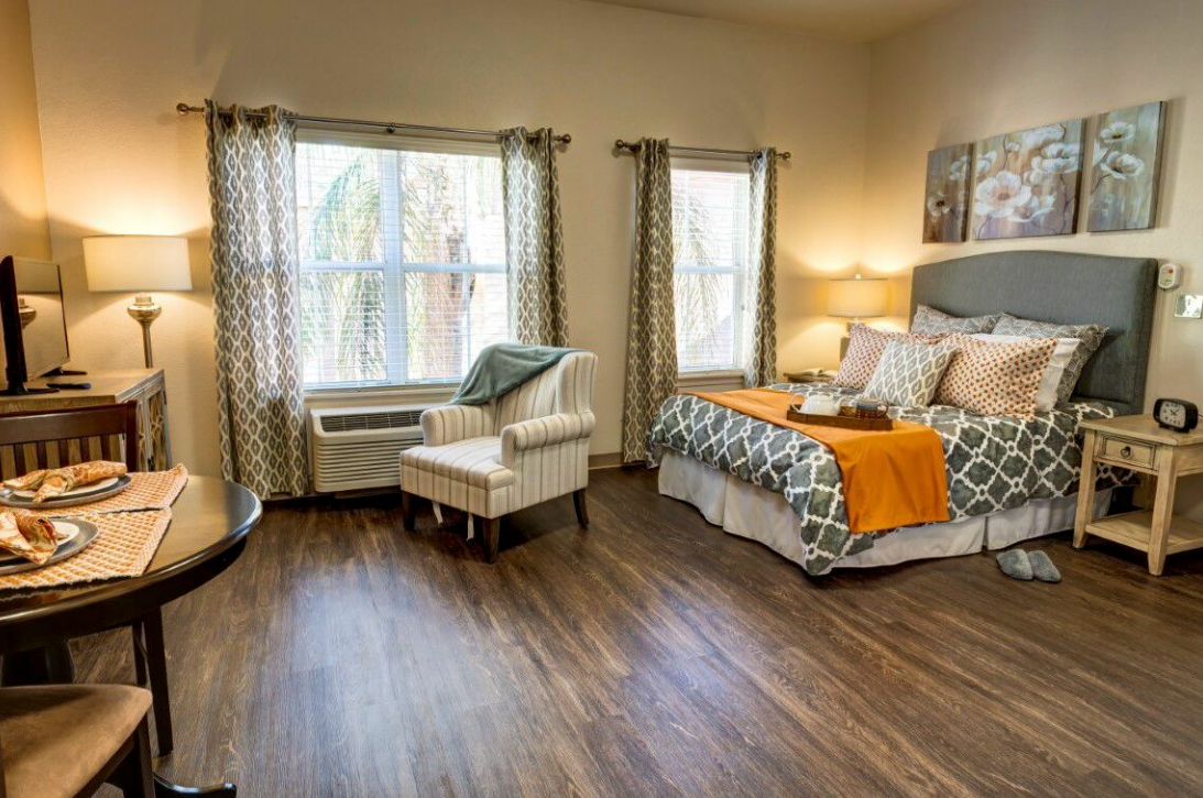 A cozy and well-lit bedroom with stylish decor and comfortable furnishings.