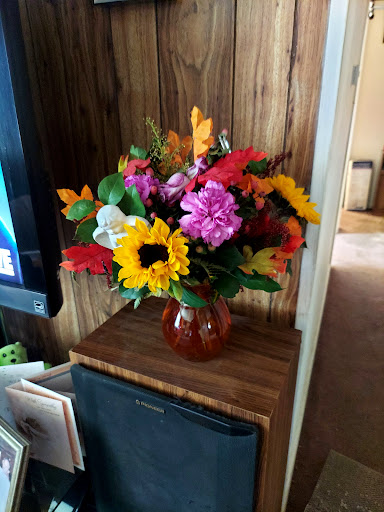 A vibrant bouquet of mixed flowers arranged in a decorative vase.