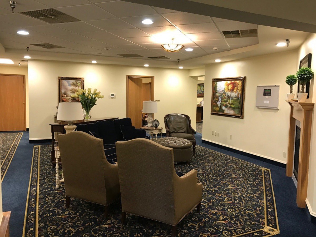 A spacious lobby area with comfortable seating, artwork on the walls, and elegant lighting.