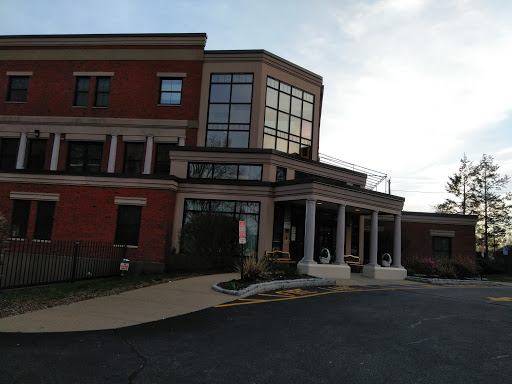 A modern brick building with large windows and an inviting entrance.